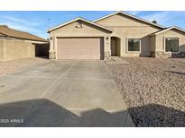 Charming single-story house with a two-car garage and low-maintenance desert landscaping at 4824 W Saint John Rd, Glendale, AZ 85308