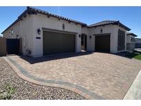 Beautiful single-story home boasts a paver driveway, two-car garage, and well-manicured landscaping at 5741 E Star Valley St, Mesa, AZ 85215