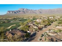 Expansive aerial view of luxury homes near a lush golf course with stunning mountain views in a desirable community at 8057 E Greythorn Dr, Gold Canyon, AZ 85118