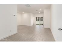Bright living room with neutral paint, recessed lighting, tile floor, and sliding glass doors at 8255 N 22Nd Dr, Phoenix, AZ 85021
