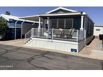 Charming home featuring a cozy front porch with white railings and awning at 8700 E University Dr # 1610, Mesa, AZ 85207
