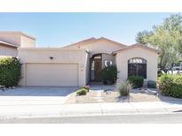 Charming single-story home with desert landscaping and a two-car attached garage at 15052 N 100Th Pl, Scottsdale, AZ 85260