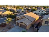 This is an aerial view of a two-story home in a residential neighborhood with mountain views at 1619 E Beretta Pl, Chandler, AZ 85286