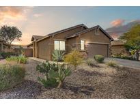 Charming single-story home boasts desert landscaping, stone accents, and an attached two-car garage at 1635 W Owens Way, Anthem, AZ 85086