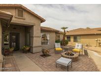 Inviting front yard with a brick patio, fire pit, and comfortable seating, perfect for enjoying outdoor evenings at 2501 E Milky Way, Gilbert, AZ 85295