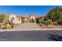 Inviting home featuring desert landscaping, a circular driveway, and a red tile roof at 37267 Ne Greythorn Cir, Carefree, AZ 85377