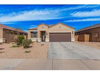 Charming single-story home featuring a two-car garage, neutral stucco, and low maintenance desert landscaping at 1250 E Eric Pl, Casa Grande, AZ 85122