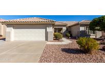 Charming single-story home showcasing low-maintenance landscaping and a two-car garage at 16476 W Limestone Dr, Surprise, AZ 85374