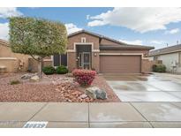 Charming single-story home with desert landscaping and a two-car garage at 20529 N 94Th Ln, Peoria, AZ 85382