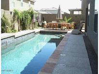 Beautiful in-ground pool with basketball hoop and outdoor dining area at 2270 E Palm Beach Dr, Chandler, AZ 85249