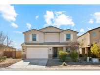 Two-story home featuring a two-car garage, neutral stucco, shuttered windows, and low maintenance landscaping at 37292 N Yellowstone Dr, San Tan Valley, AZ 85140
