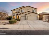 Two-story home with a desert landscaped front yard and three-car garage at 42735 W Bravo Dr, Maricopa, AZ 85138