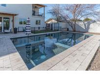 Beautiful backyard swimming pool with a patio and comfortable lounge chairs at 4306 E Flower St, Phoenix, AZ 85018