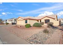 Single-story home with a desert landscape, complemented by a tan exterior and tile roof, perfect for low-maintenance living at 8736 W Kathleen Rd, Peoria, AZ 85382