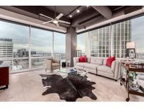 Bright living room with large windows, tile floor, modern furniture, and city views at 1 E Lexington Ave # 1210, Phoenix, AZ 85012