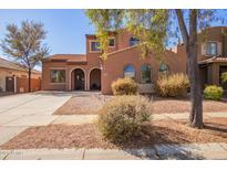 Charming two-story home with a tile roof, arched windows, and desert landscaping at 10684 N 161St Ave, Surprise, AZ 85379