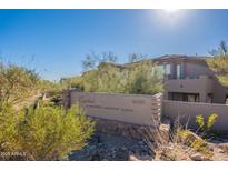 Cachet at McDowell Mountain Ranch community sign features desert landscaping and neutral-toned architecture on a sunny day at 16420 N Thompson Peak Pkwy # 2120, Scottsdale, AZ 85260