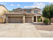 Beautiful two-story home with a three-car garage, desert landscaping, and solar panels at 18118 W Golden Ln, Waddell, AZ 85355