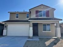 Charming two-story home featuring a two car garage and a well-maintained front yard at 23229 W Florence Ave, Buckeye, AZ 85326