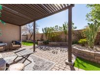 Cozy back patio featuring a pergola, brick flooring, and a seating area perfect for outdoor relaxation at 2645 W Florentine Rd, Phoenix, AZ 85086