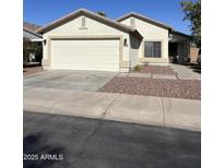 Charming single-story home featuring a two-car garage, desert landscaping, and a welcoming front entrance at 30169 N Sunray Dr, San Tan Valley, AZ 85143