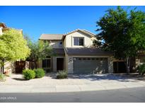 Charming two-story home with a neutral stucco facade, a tile roof, and a well-manicured front yard at 4757 E Amber Sun Dr, Cave Creek, AZ 85331