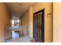 Inviting condo entrance with security door, neutral colors, and nearby staircase access at 5401 E Van Buren St # 2050, Phoenix, AZ 85008