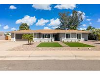 Charming single-story home featuring a well-manicured front yard and a neutral color palette at 5412 E Tierra Buena Ln, Scottsdale, AZ 85254