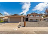 Charming home showcasing a well-kept front yard, a spacious garage, and a quaint mailbox post at 7539 N 50Th Ave, Glendale, AZ 85301