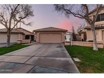 Charming single-story home featuring a spacious driveway and well-maintained front yard with desert landscaping at 80 S Maple Ct, Chandler, AZ 85226