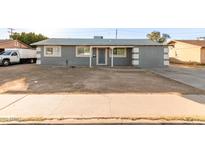 Charming single-story home with a gray exterior, covered entry, and low-maintenance landscaping at 836 S Pasadena St, Mesa, AZ 85210