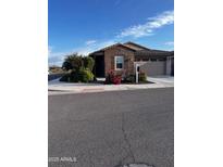Charming single-story home with brick accents, landscaped front yard, and attached two-car garage at 9341 W Willow Bend Ln, Phoenix, AZ 85037