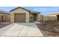 Charming single-story home featuring a two-car garage, desert landscaping, and a covered entryway at 12089 E Sunflower Ln, Florence, AZ 85132