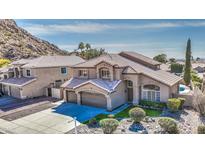 Stunning two-story home featuring a three-car garage and well-maintained landscaping at 1349 E Rock Wren Rd, Phoenix, AZ 85048