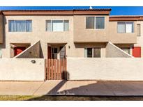 Inviting townhouse featuring a private front patio and a charming wooden gate at 2040 S Longmore -- # 5, Mesa, AZ 85202