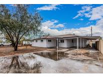 Charming exterior of this newly renovated home featuring a covered parking area and spacious front yard at 2904 W Coolidge St, Phoenix, AZ 85017