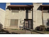 Inviting condo featuring a gated entrance and desert landscaping; great location in Phoenix, Arizona at 3107 W Loma Ln, Phoenix, AZ 85051