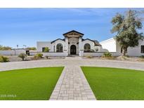 Stunning white home with a large driveway and well-manicured lawn, showcasing curb appeal at 7816 S Lakeshore Dr, Tempe, AZ 85284