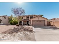 Home with a two-car garage, desert landscaping, and views of the roof and surrounding homes at 1114 S Grenoble --, Mesa, AZ 85208