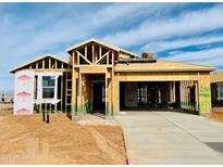 New construction home featuring wood framing, a concrete driveway, and Thermo-Sheath structural sheathing at 11980 E Aster Ln, Florence, AZ 85132