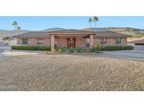 Charming brick home with meticulous landscaping and a desert-friendly front yard at 1201 W Dahlia Dr, Phoenix, AZ 85029