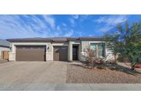 Charming single-story home featuring a three car garage, desert landscaping, and a welcoming entrance at 12716 W Mclellan Rd, Glendale, AZ 85307