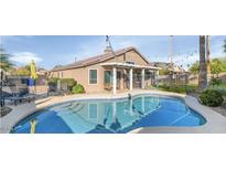 Inviting backyard pool with lounge chairs and a covered patio area, perfect for outdoor entertaining and relaxation at 1363 N Mckenna Ln, Gilbert, AZ 85233