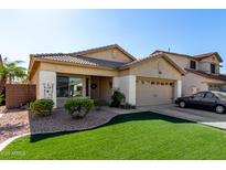 Charming single-story home featuring a well-maintained yard and covered entry at 14547 W Evans Dr, Surprise, AZ 85379