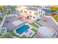 Aerial view of a beautiful backyard with a pool, patio, and solar panels on the home at 15652 N 175Th Ct, Surprise, AZ 85388