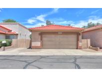 Inviting single-story home featuring a red tile roof and a spacious two-car garage at 1762 N Terrace Cir, Casa Grande, AZ 85122