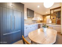 Kitchen featuring modern cabinetry, an eat-in kitchen table, and stainless steel appliances at 2201 N Central Ave # 2A, Phoenix, AZ 85004