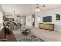 Open-concept living room with a dining area and kitchen, showcasing modern furnishings and neutral tones at 22905 N 19Th Way, Phoenix, AZ 85024