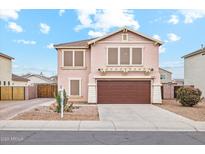 Charming two-story home with a well-maintained front yard and a two-car garage at 2472 W Hawks Eye Ave, Apache Junction, AZ 85120