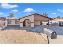 Charming single-story home with a covered carport and low-maintenance desert landscaping at 2815 W Charleston Ave, Phoenix, AZ 85053